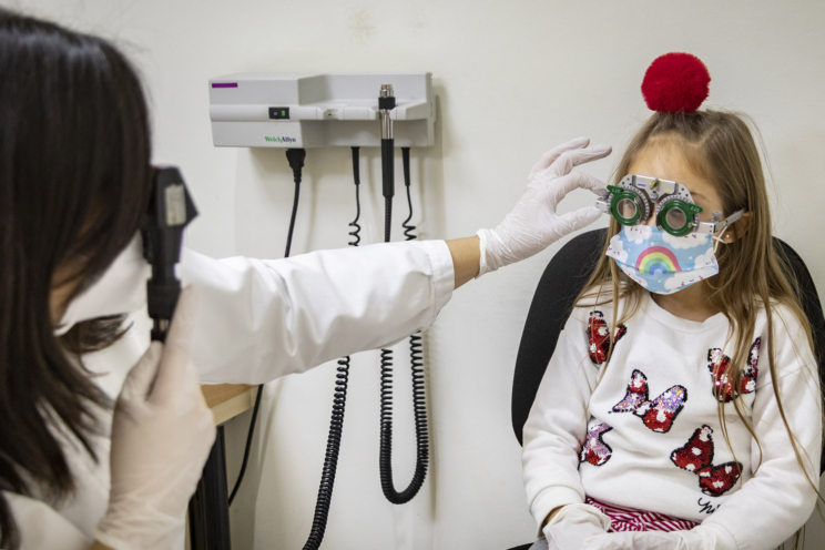Optometrista examinant una pacient de Pediatria